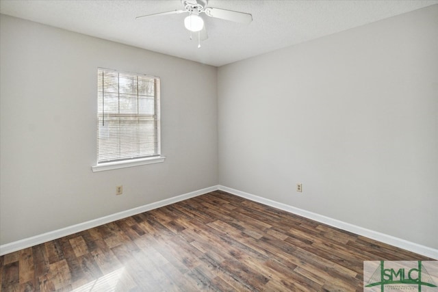 empty room featuring ceiling fan, a textured ceiling, and dark hardwood / wood-style flooring