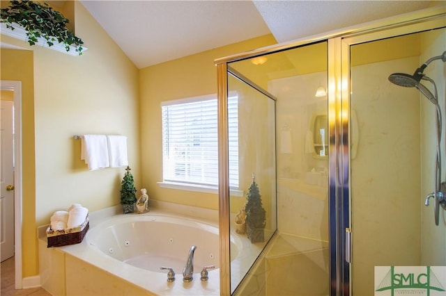 bathroom featuring lofted ceiling and separate shower and tub