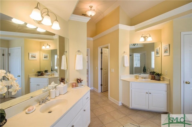 bathroom featuring tile patterned flooring, vanity, and crown molding