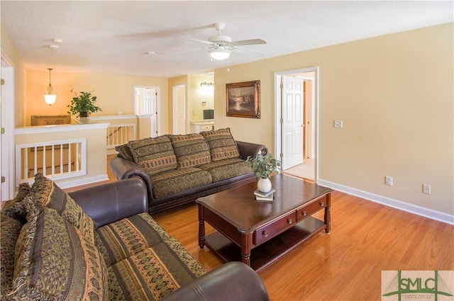 living room with ceiling fan and light wood-type flooring