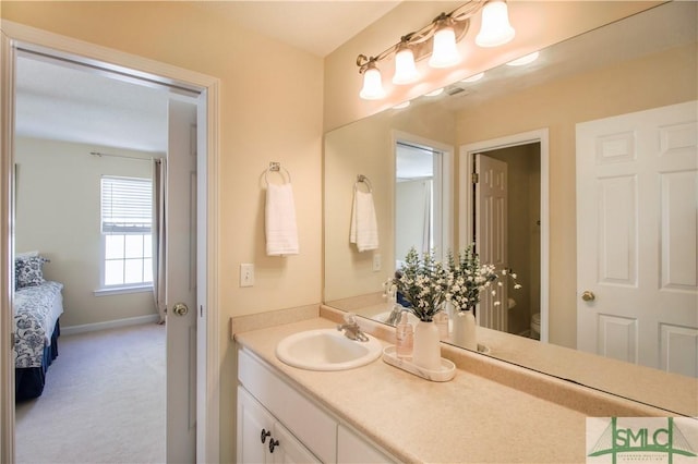 bathroom featuring vanity and toilet