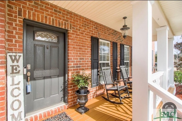 doorway to property featuring covered porch