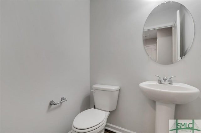 bathroom featuring sink and toilet