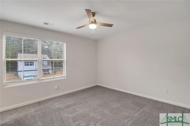 empty room with ceiling fan and carpet flooring