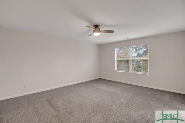 empty room featuring ceiling fan and carpet