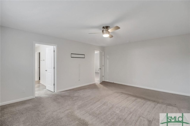 carpeted empty room featuring ceiling fan