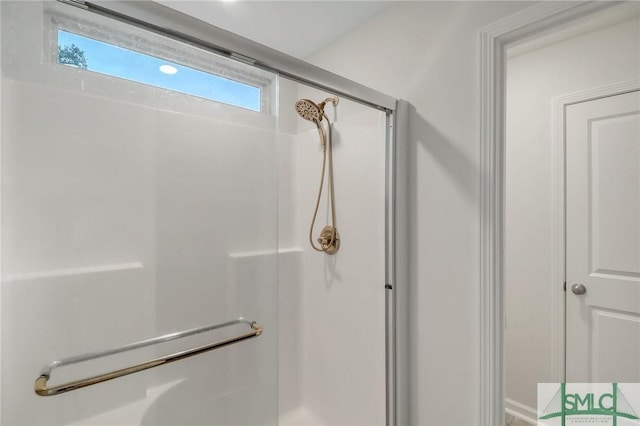 bathroom featuring a shower with shower door