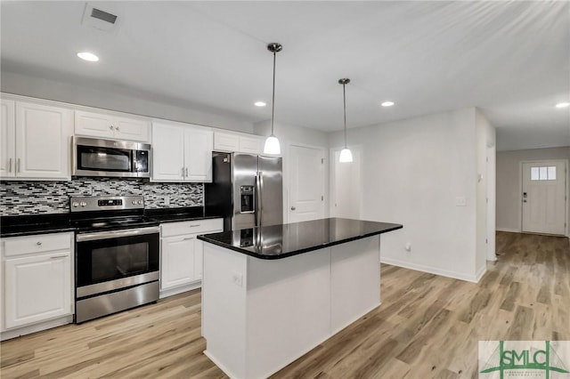 kitchen featuring a kitchen island, white cabinetry, appliances with stainless steel finishes, and hanging light fixtures