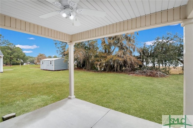 view of yard with a storage shed, a patio area, and ceiling fan