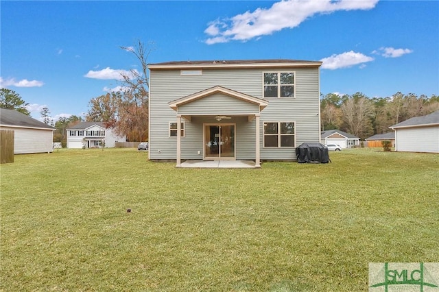 back of property with a patio area and a lawn