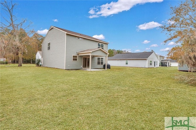 rear view of property with a lawn and a patio