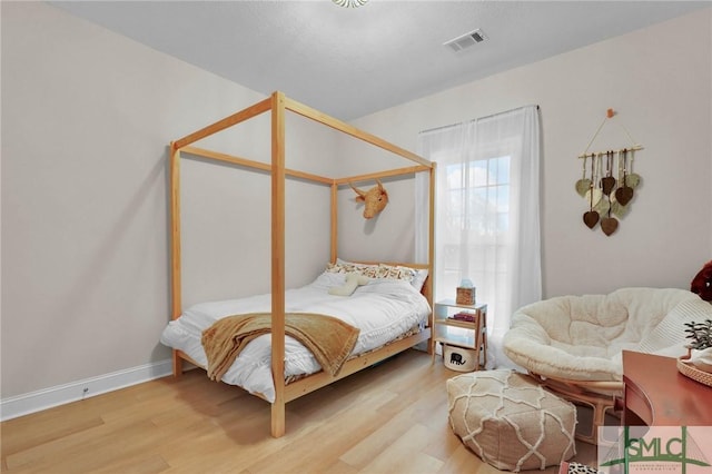 bedroom with light hardwood / wood-style flooring