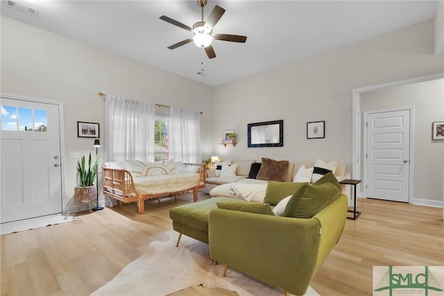 living room featuring ceiling fan and light hardwood / wood-style flooring