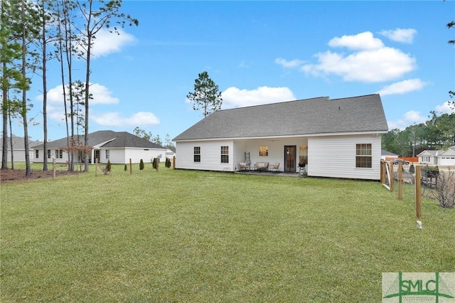 back of house featuring a patio and a lawn