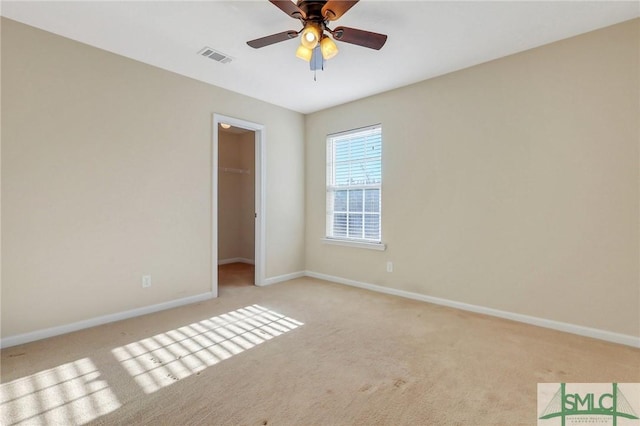 unfurnished room with ceiling fan and light colored carpet