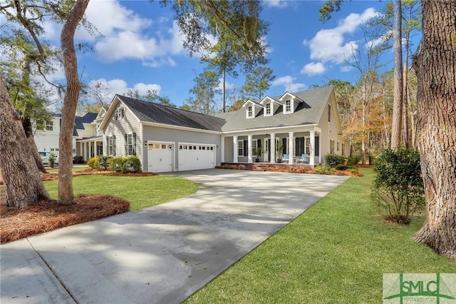 view of front of house with a garage, a porch, and a front yard