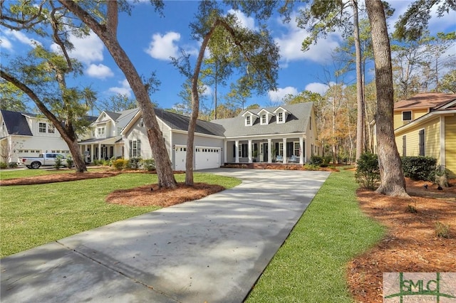 cape cod home featuring a garage and a front yard