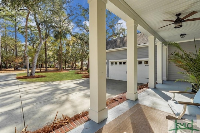 view of patio featuring ceiling fan, a garage, and covered porch