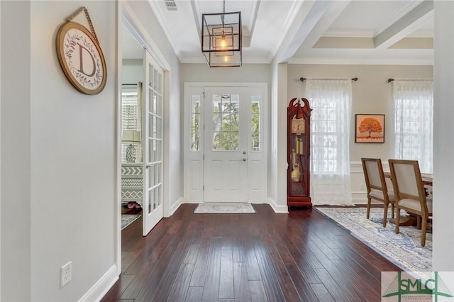 entryway with ornamental molding and dark hardwood / wood-style floors