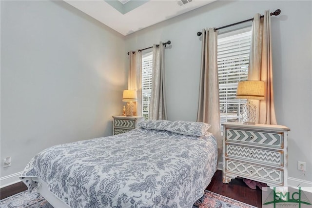 bedroom with dark hardwood / wood-style flooring