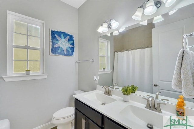 bathroom with vanity, toilet, and a shower with shower curtain