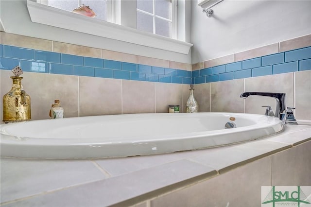 bathroom with a relaxing tiled tub