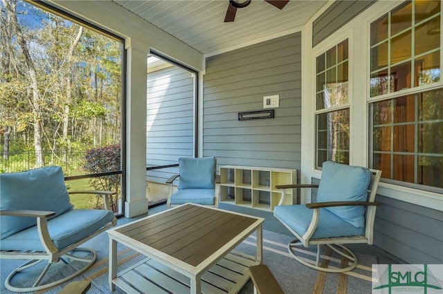 sunroom / solarium featuring ceiling fan