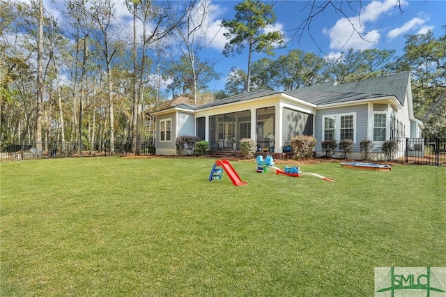 back of property featuring a lawn and a sunroom