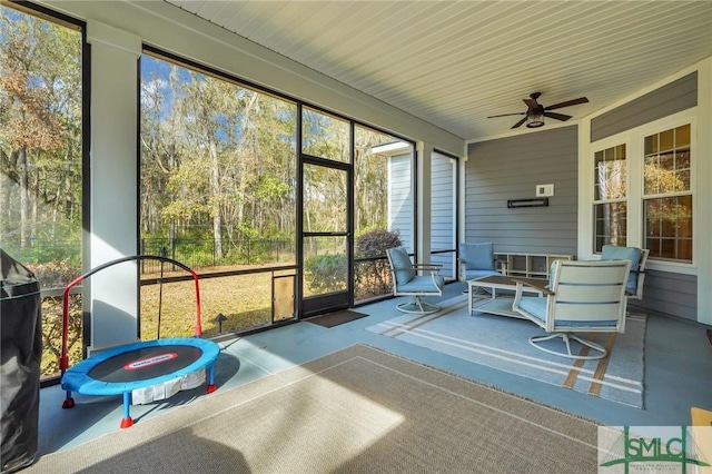 sunroom featuring ceiling fan