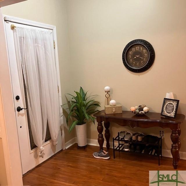 doorway featuring dark wood-type flooring