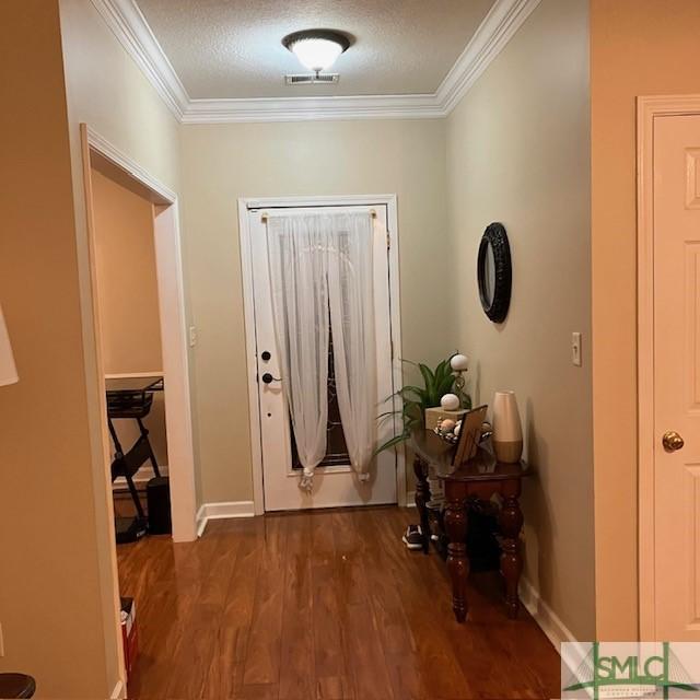 145 J Hendley Ct, Richmond Hill, GA 31324 - foyer with visible vents, ornamental molding, baseboards, and wood finished floors