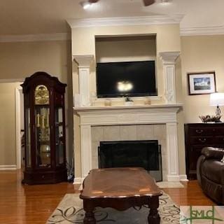 sitting room featuring crown molding, dark hardwood / wood-style floors, and a fireplace