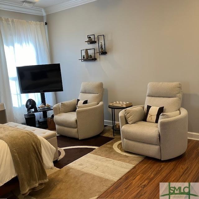 living room featuring crown molding and hardwood / wood-style flooring