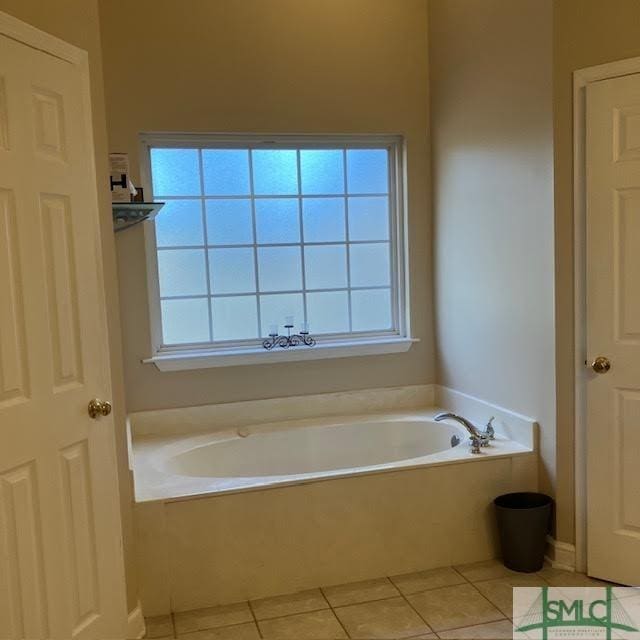 bathroom featuring a washtub and tile patterned flooring