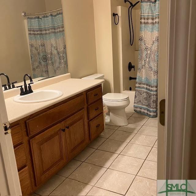 full bathroom featuring toilet, tile patterned floors, shower / bathtub combination with curtain, and vanity