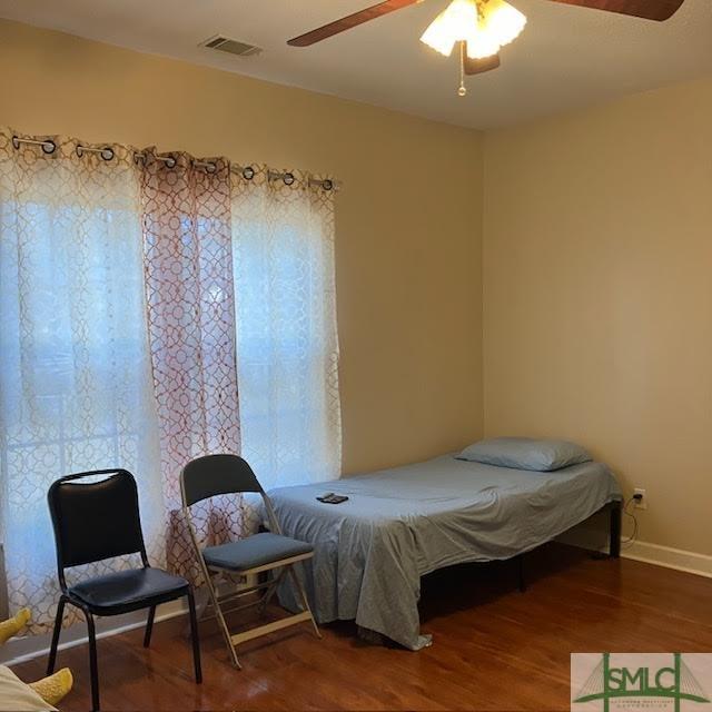 bedroom with ceiling fan and wood-type flooring