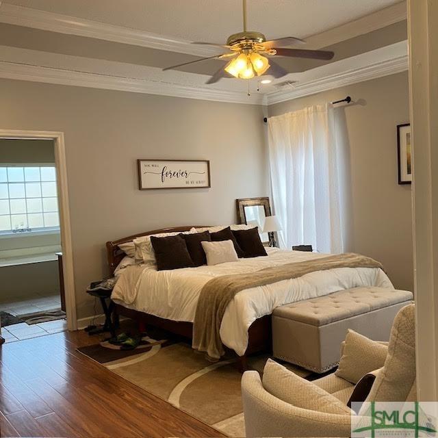 bedroom featuring crown molding, ceiling fan, and hardwood / wood-style floors