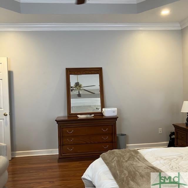 bedroom with dark wood-type flooring and ornamental molding