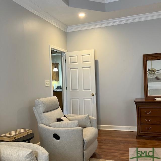 living area featuring crown molding and wood-type flooring