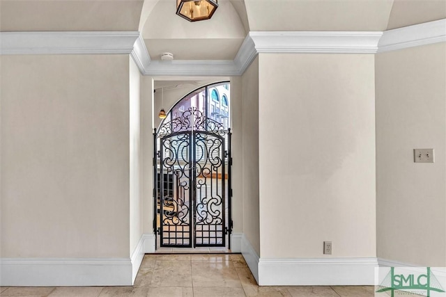 tiled foyer featuring baseboards and ornamental molding