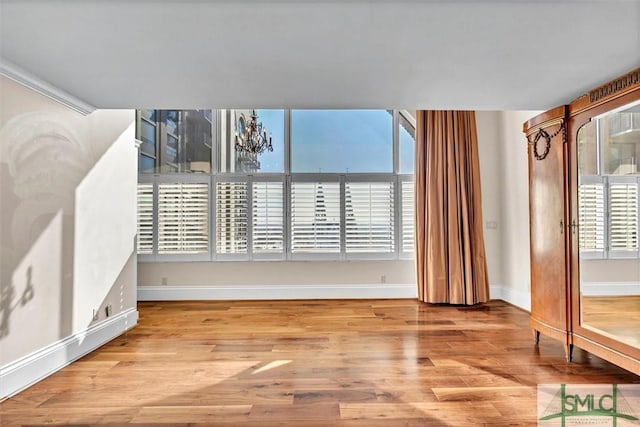 interior space featuring light wood-type flooring and baseboards