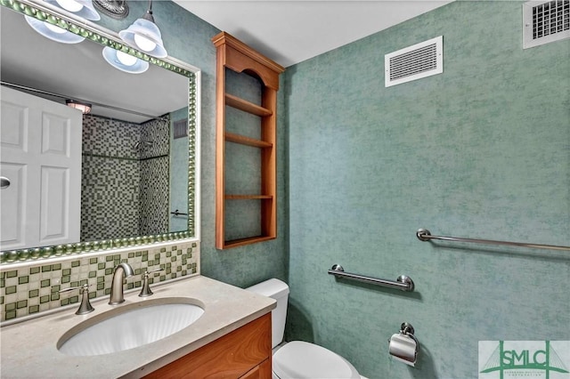 bathroom featuring vanity, toilet, visible vents, and backsplash