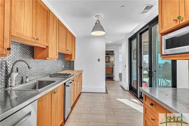 kitchen with visible vents, decorative backsplash, a sink, dishwashing machine, and white microwave