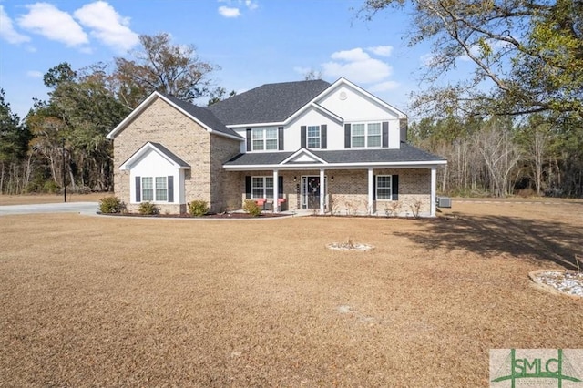 front facade with a front lawn and covered porch