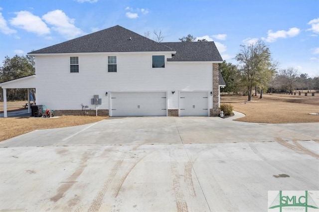 rear view of house with a garage