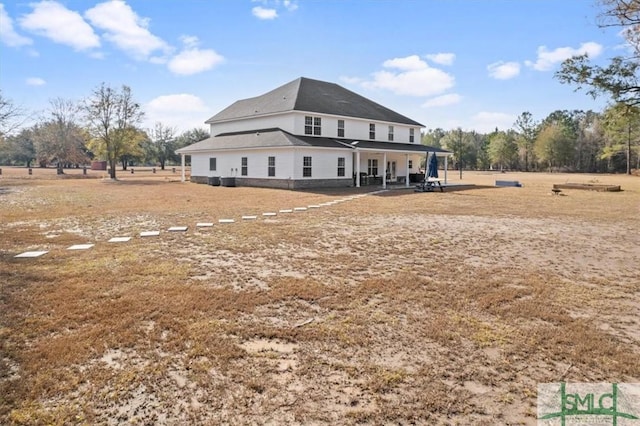 back of property with a patio