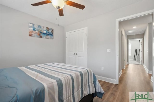 bedroom featuring hardwood / wood-style flooring, ceiling fan, and a closet