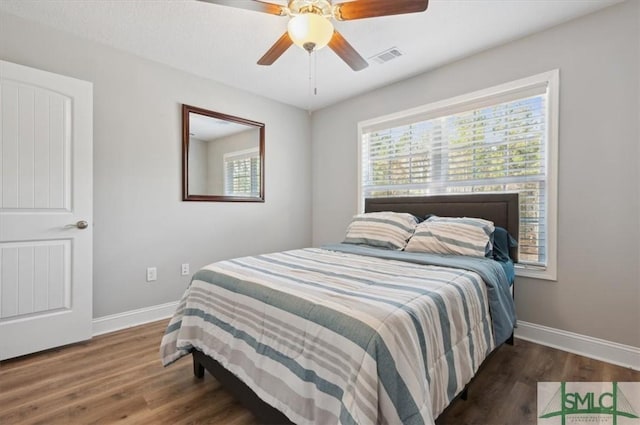 bedroom featuring ceiling fan and dark hardwood / wood-style flooring