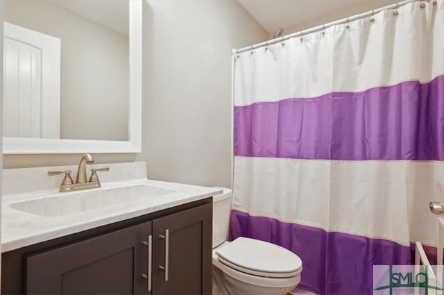 bathroom featuring vanity, toilet, and a shower with shower curtain