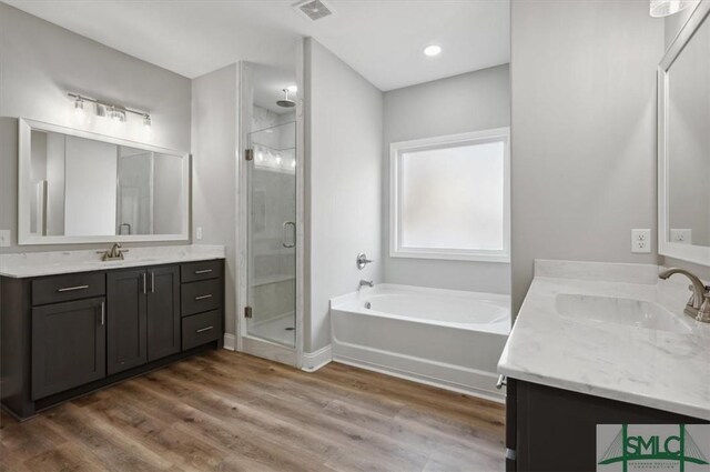 bathroom with vanity, separate shower and tub, and hardwood / wood-style floors